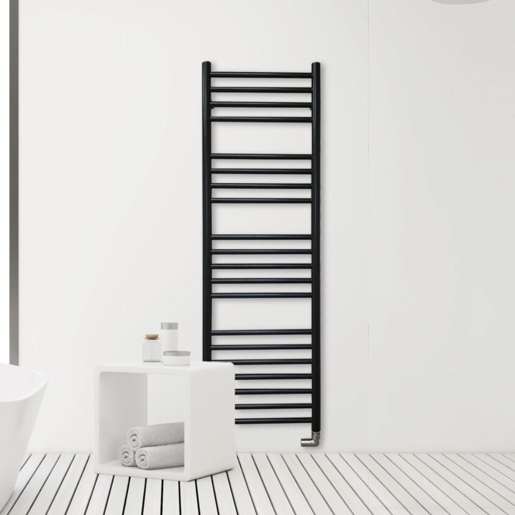Lifestyle image of the The Sussex Range by JIS Ashdown 1250mm x 400mm Black Heated Towel Rail installed on a white wall behind a bathroom table